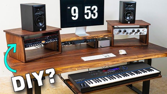 A custom wooden home studio desk with monitor speakers, keyboard, and audio rack gear.